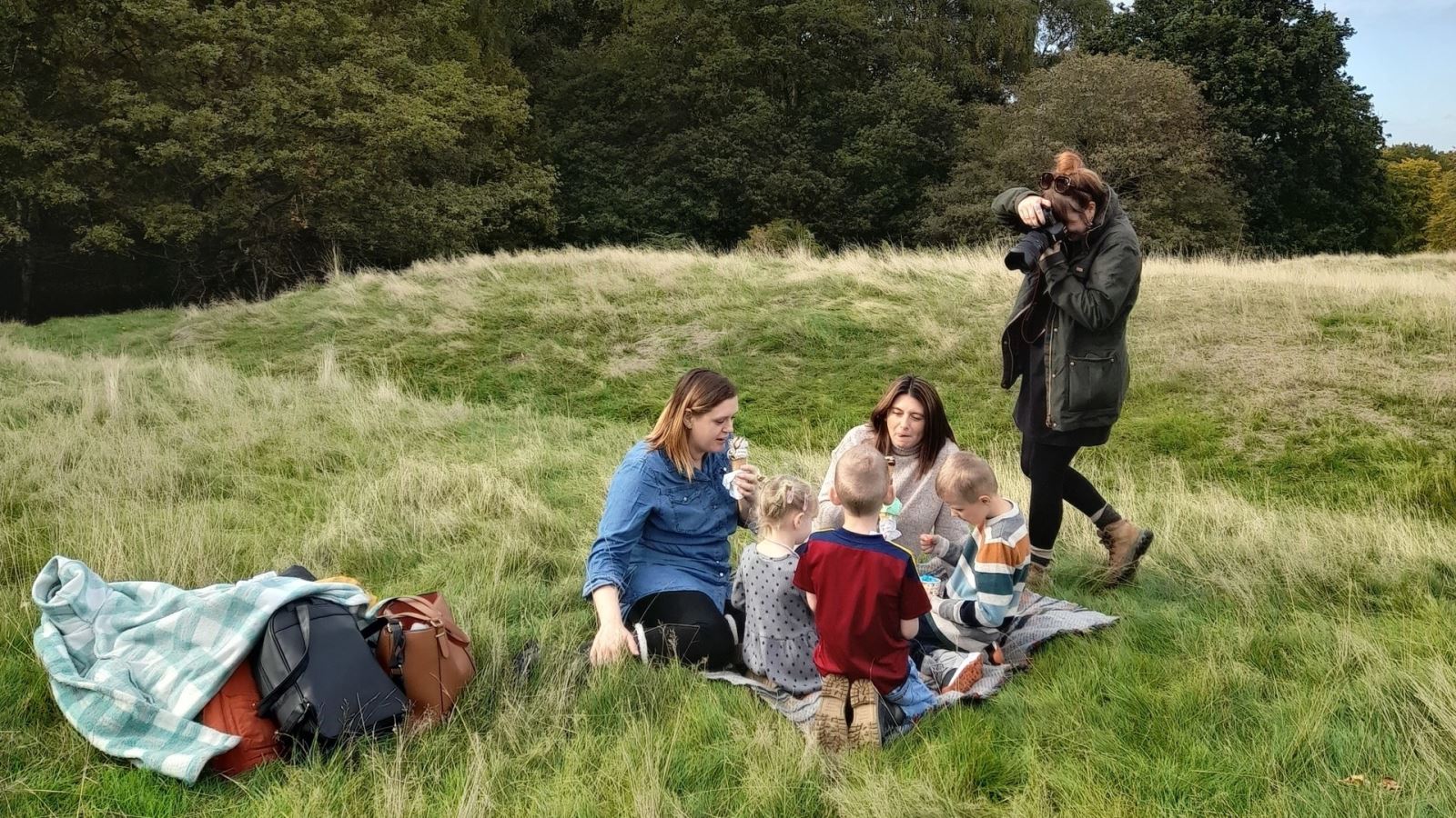 Family having a picnic in a field at Epping Forest