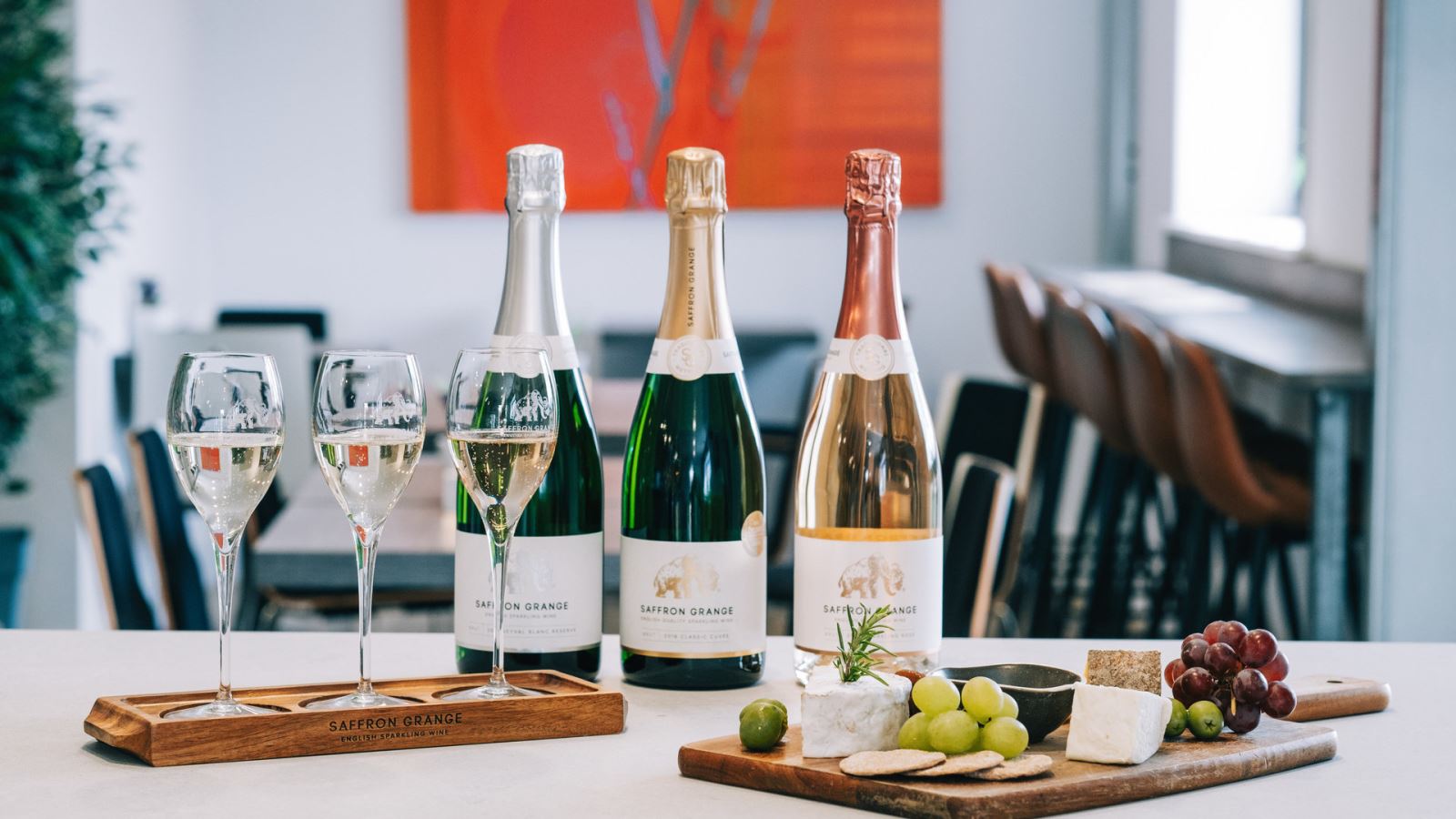 Wine bottles, wine glasses, and cheese board at Saffron Grange Vineyard in Essex