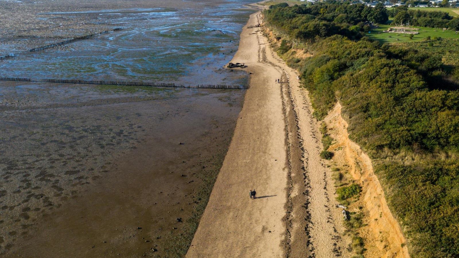 Aerial view of beach and cliffs at Cudmore Grove Country Park on Mersea Island