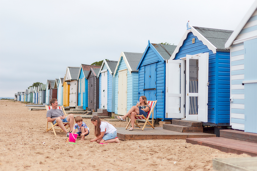 family and beach huts on mersea island